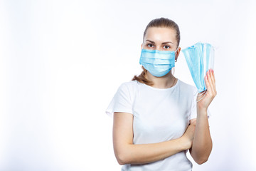 A girl in a protective medical mask holds in her hands means to protect the respiratory tract from the virus.