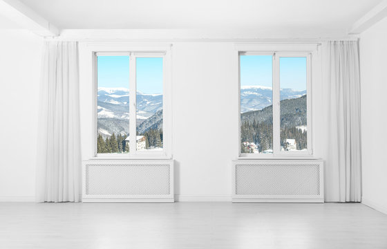 Beautiful view of snowy mountains through windows
