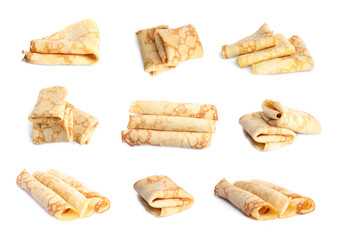 Set of delicious thin pancakes on white background
