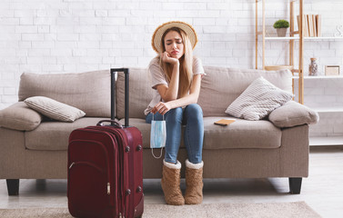 Obraz premium Travel cancel and sad woman stay at home