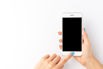 Woman’s hands using mobile phone with empty screen isolated on white background. Top view