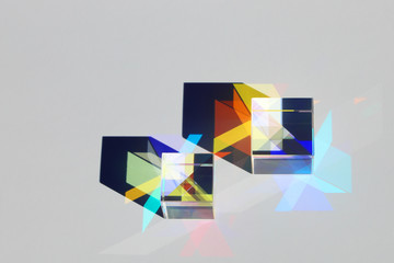 Two x-cubes cast shadows and create a colored design
