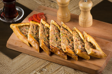 Traditional turkish baked dish pide. Turkish pizza pide, Middle eastern appetizers. Turkish cuisine. Top view. Pide with meat filling.