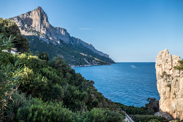 Fototapeta na wymiar The coast line of Baunei with red rock mountains
