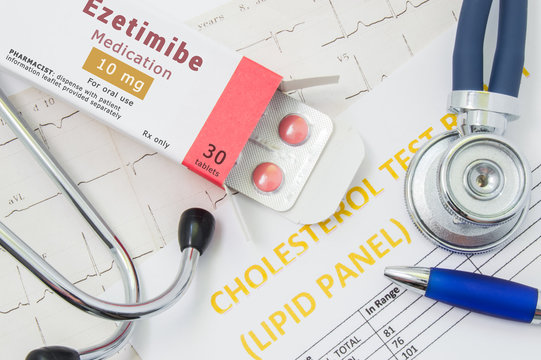 Ezetimibe drug for cholesterol lowering therapy concept photo. Open packaging with medication tablets, on which written "Ezetimibe", lies near stethoscope, result analysis on cholesterol (lipid panel)