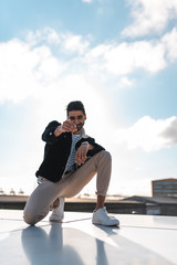 Young man posing on Rooftop in sunny weather, casual clothing