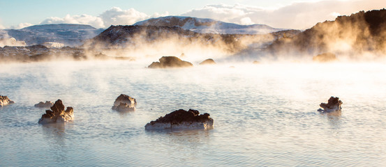 Landscape view of the Blue Lagoon in Iceland during winter with steam and snow.