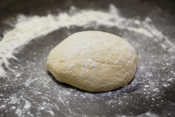 flour dough for baking cookies on the kitchen table
