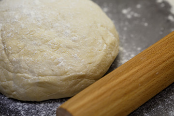 flour dough for baking cookies on the kitchen table