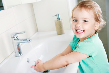 Child washing hands in bathroom,healthy lifestyle.