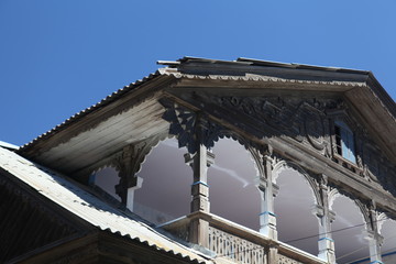 Old wooden house with carved windows, roof on Gilyanskaya Street, 17 in Astrakhan city, Russia....