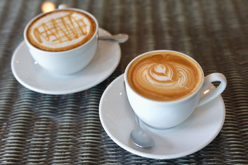 hot caramel macchiato and latte coffee drink put on table in cafe