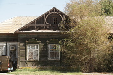 Decorated roof of old wooden rural house in Astrakhan city, Russia. Building facade with carved...