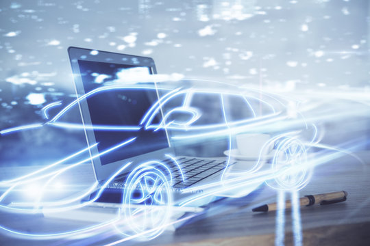 Desktop computer background in office with automobile hologram drawing. Multi exposure. Tech concept.