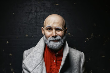 brutal man with a beard in winter clothes / portrait person with a gray beard, hipster warm clothes winter