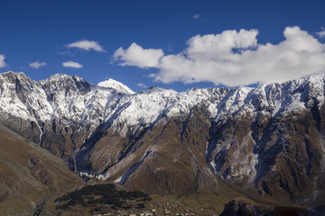 High mountains in Kazbegi district - peaks with snow on it.