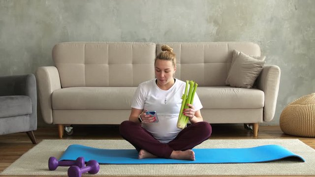 Pregnant girl goes in for sports and eats celery