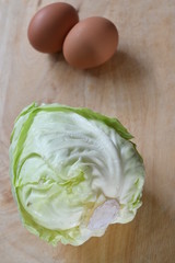 fresh cabbage organic vegetable and egg put on wood cutting board in kitchen prepare cooking food