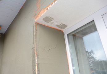 How to skim a wall around the window outdoors. Finish plaster on window problem corner.