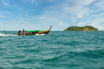 Traditional wooden boat sail on the sea tropical bay to diving at small island, Ranong Province, Thailand, Asia.