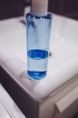 blue bottle of liquid soap on the sink