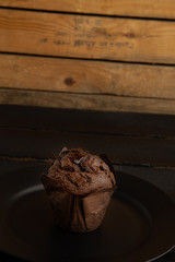 Chocolate cupcake on black wooden background