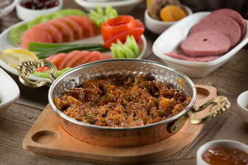 Traditional Turkish Breakfast with sesame bagel and fry egg with sausage.Used ceramic breakfast set and copper egg pan.