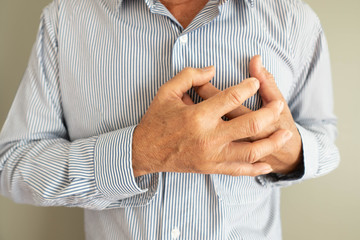 Heart attack problems. Elderly man suffering from severe chest pain. Warning signs of unstable...