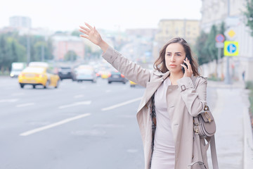 business lady stands road, cars, traffic, urban style, travel in the city, woman and cars
