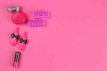 Obraz na płótnie Canvas Children 's plastic toys-cosmetics, Barber set, on pink background, layout with copy space