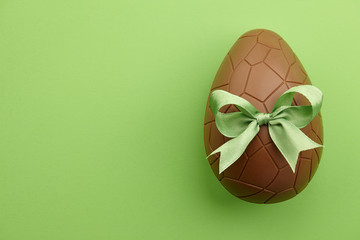 Chocolate Easter egg with green ribbon bow