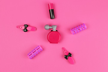 Obraz na płótnie Canvas Children 's plastic toys-cosmetics, Barber set, on pink background, layout