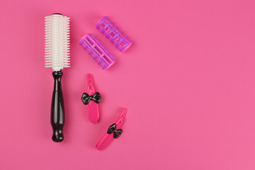 Children's plastic Barber tools, on pink background, layout with copy space