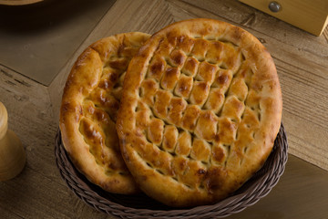 Turkish ramazan pidesi - Traditional Turkish ramadan flatbreads which bake during ramadan month. Blue stone background. Top view
