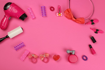 Obraz na płótnie Canvas Children 's plastic toys-cosmetics, Barber set, on pink background, layout with copy space