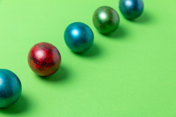 Easter card concept. colored easter eggs in a row on a light green background