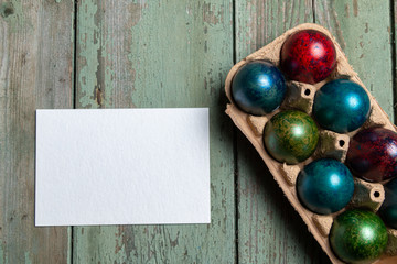 Easter holiday concept with brightly colored eggs in a paper egg container