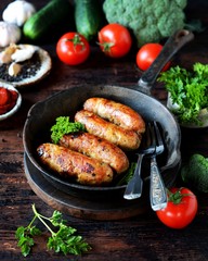 Homemade chicken (turkey) sausages fried in a pan. picnic. rustic