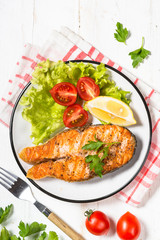 Grilled salmon fish steak on white.