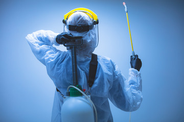 Scientist holding chemical sprayer for sterilization and decontamination of viruses, germs, pests,...