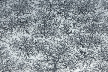 Gray white hoar crystals closeup background texture on glass