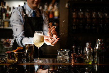 Bartender splits pieces of ice for cocktail.