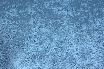 Blue frost crystals background texture on glass