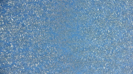 Fototapeta premium Blue hoarfrost on glass background texture