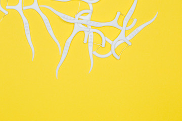 Plastic toothpick on a yellow isolated background. Hygiene and dental care.