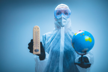 Medical doctor and scientist holding Earth globe for presenting virus pandemic outbreak on the whole planet. Global warming and temperature rising presentation.