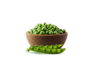 Green peas on a wooden bowl isolated on a white background. Vegetables with copy space for text. Green peas isolated on white. Isolated macro food photo close up from above on white background.