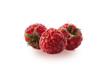 Raspberries isolated on white background. Three ripe raspberries close-up. Raspberry with copy...