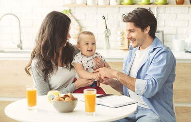 Young family enjoying morning together at kitchen