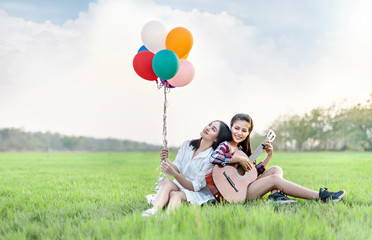 women relaxing on green  field